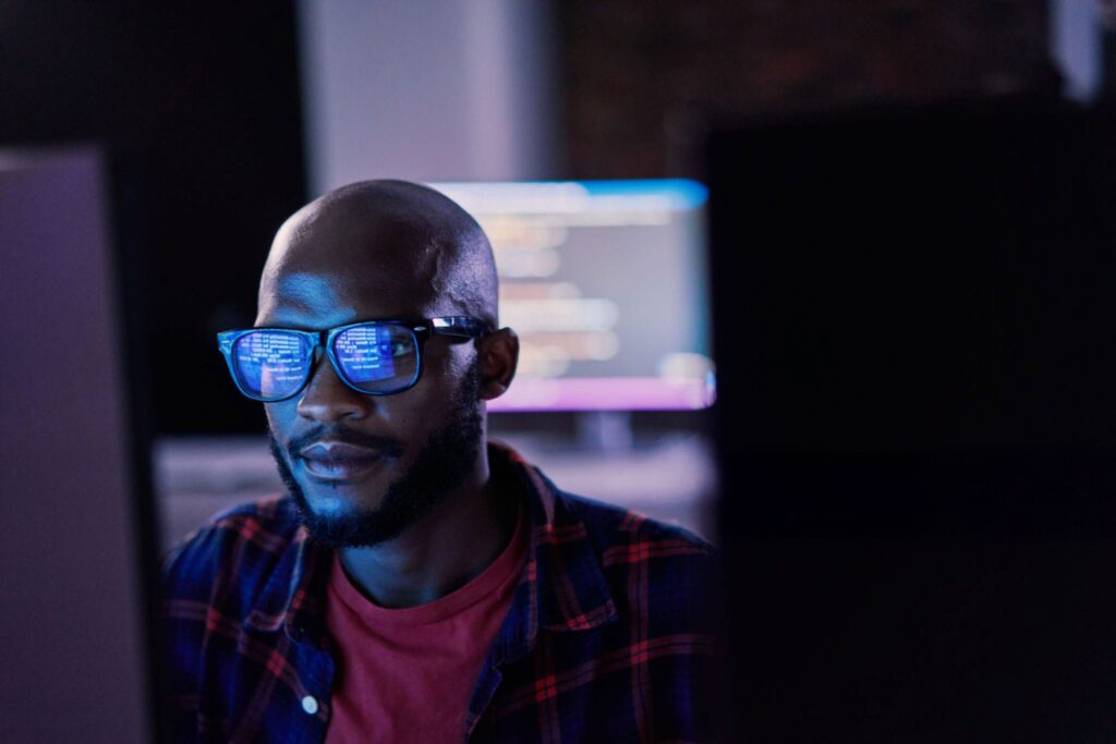 Engineer working at a desk with multiple monitors